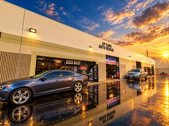 AP Cars building with a sedan and pickup outside.