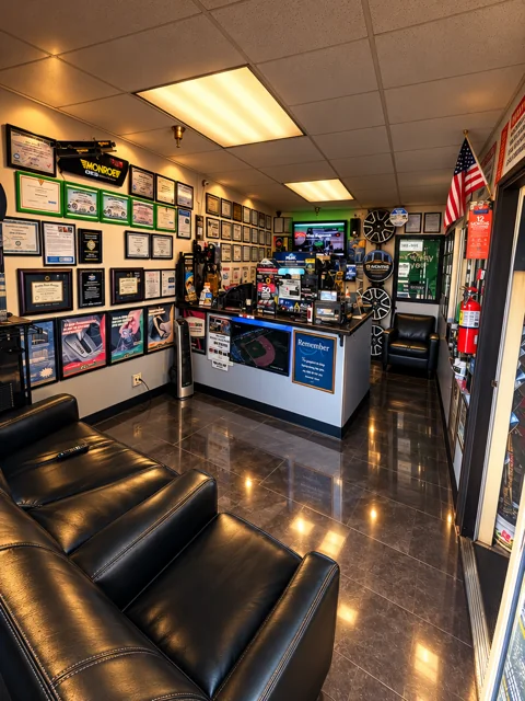 Black seating beside wall displays and the reception counter.